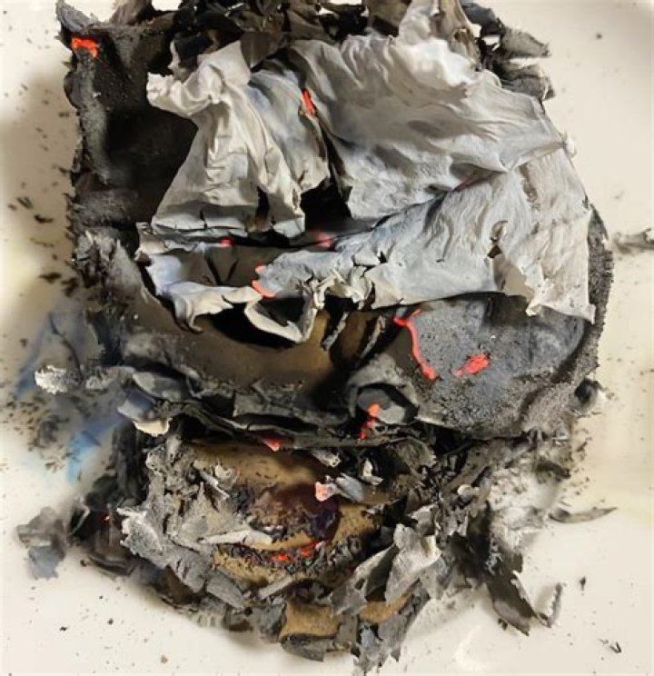 What happens when a piece of paper is burned inside a tin can?