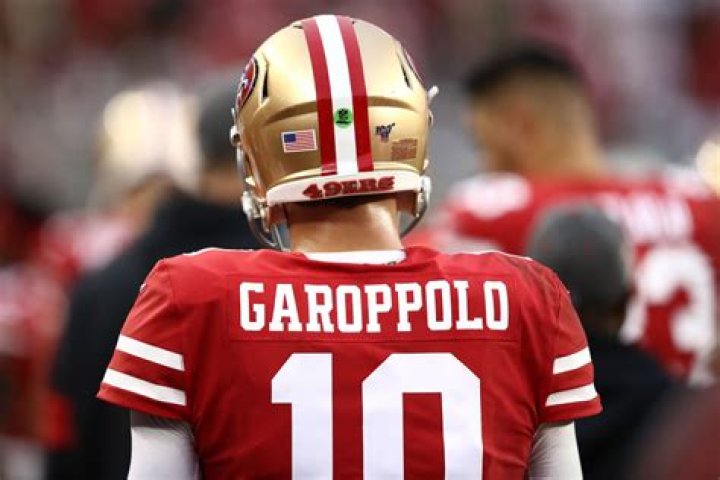 Why do quarterbacks have a green sticker on their helmet?